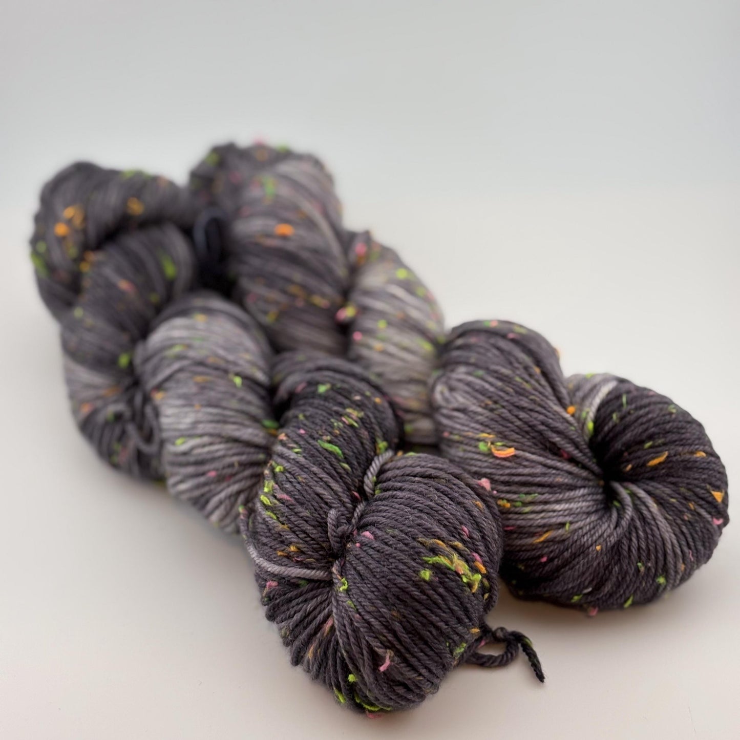Hand Dyed Yarn, DK Weight, Superwash Merino and Neon Donegal Nep in Black Light